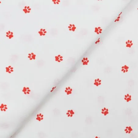 Tissu coton blanc milleraie imprimé pattes de chien rouge